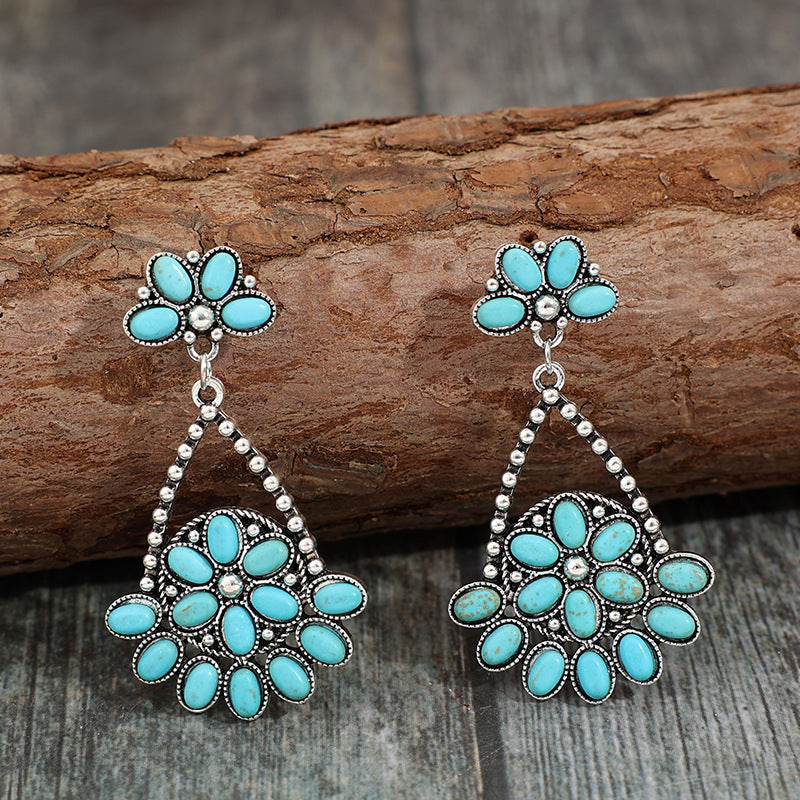 Close-up image of the Bohemian Turquoise Teardrop Earrings highlighting the vibrant turquoise stones and sleek setting.