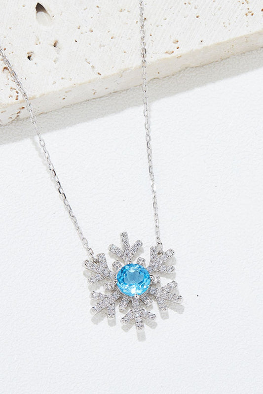 Sterling Silver Topaz Snowflake Pendant Necklace featuring a snowflake pendant adorned with sparkling topaz stones on a sterling silver chain.